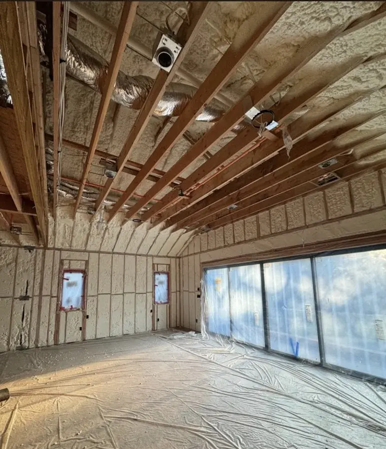 Interior walls and ceiling insulated with spray foam during new construction in Providence